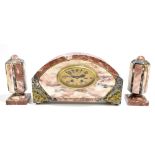 An Art Deco marble clock garniture, the domed clock with gilt metal mounts and oval dial set with