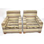 A pair of contemporary armchairs in striped fabric on block supports (2).