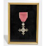 A George V MBE medal, framed.