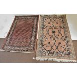 A contemporary Eastern style rug with stylised detail on a predominately red ground and a modern rug