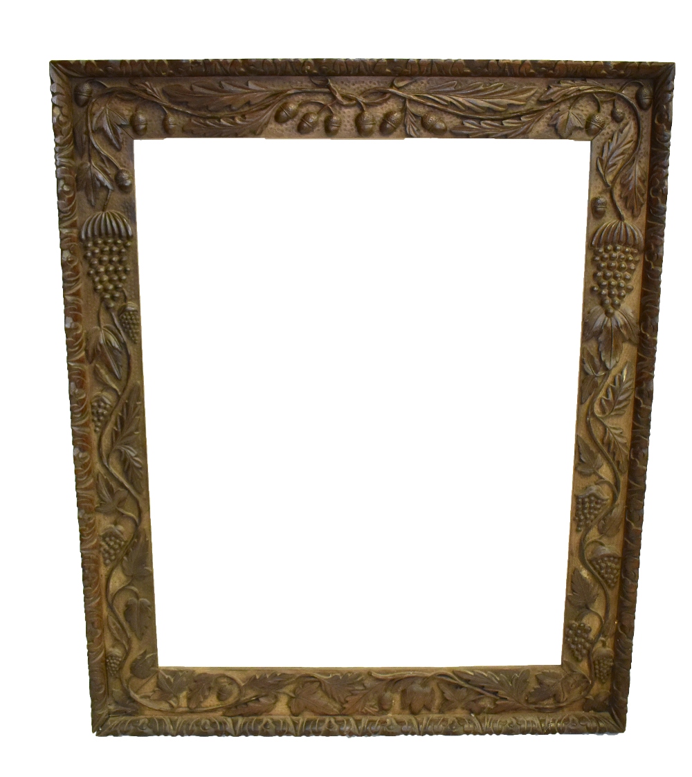 A large Victorian carved oak frame suitable for a mirror plate or picture, the rebate 92 x 73cm.