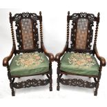 A pair of c1900 walnut elbow chairs in the 17th century style with pierced carved detail, canework