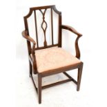 A late George III country made beech and oak elbow chair with padded drop-in seat and square section
