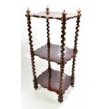 A Victorian rosewood three tier whatnot raised on barleytwist supports, height 82cm, length 34cm.