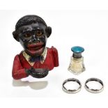 A cast iron 'Little Joe' novelty money box, height 13cm, two hallmarked silver napkin rings and a