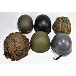 Five military and public service helmets comprising German Army M62 1A1, Italian Serbian Police,
