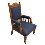 A late Victorian walnut framed library chair raised on turned column supports.Additional