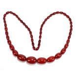 A cherry amber style beaded necklace with fifty-three beads, length 39cm, weight approx 72g.