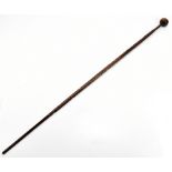 An African hardwood walking cane with knop finial and turned wrythen column support of an unusual