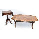 A large reproduction yew wood coffee table of rounded rectangular form with shaped gallery and