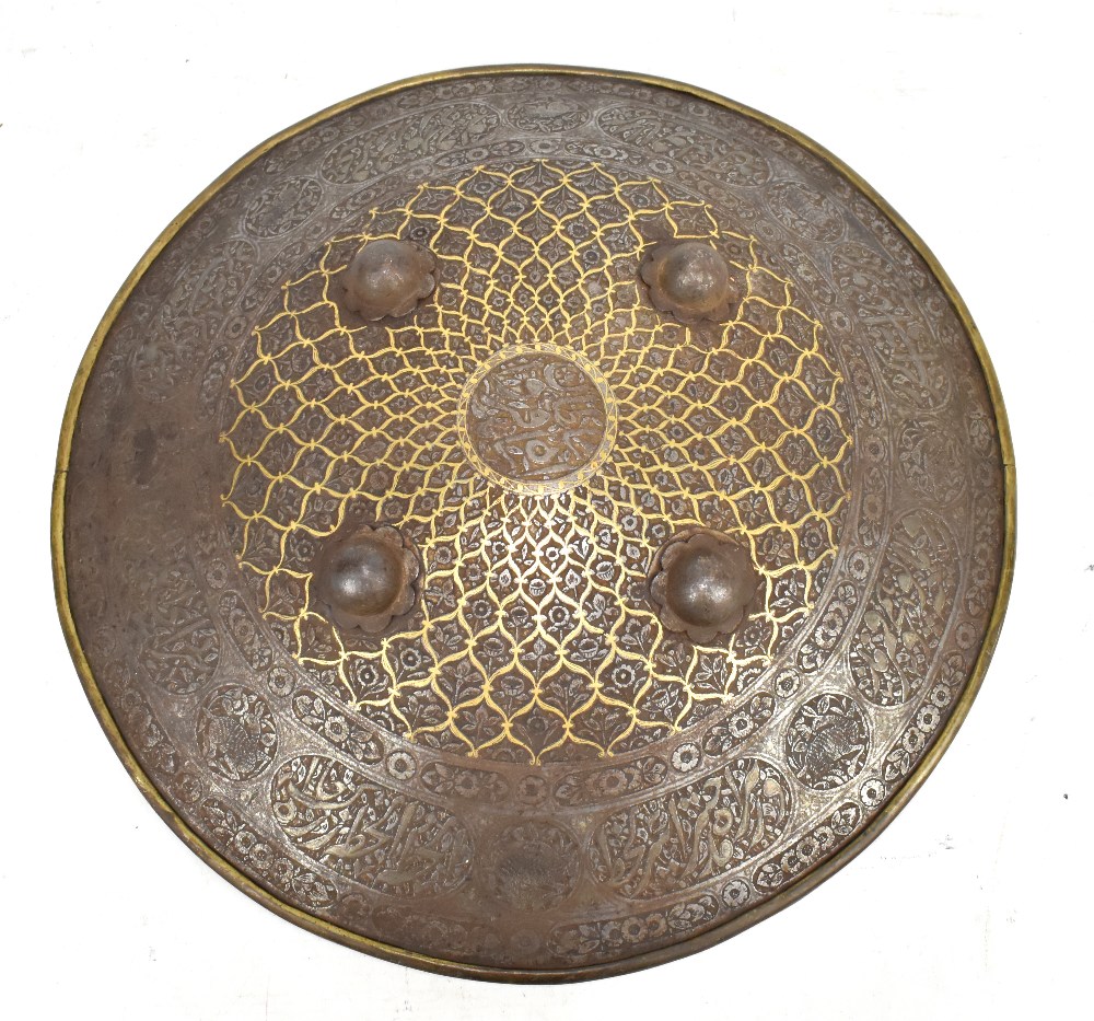 An early 19th century Indian shield (dhal) with script, floral and animal decorated border, four