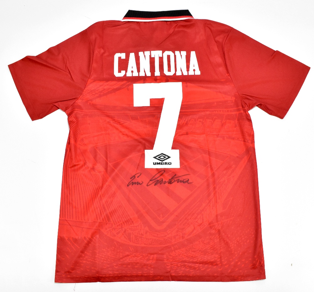 MANCHESTER UNITED FC; an Umbro retro-style shirt with embroidered logo signed by Eric Cantona to