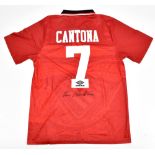 MANCHESTER UNITED FC; an Umbro retro-style shirt with embroidered logo signed by Eric Cantona to