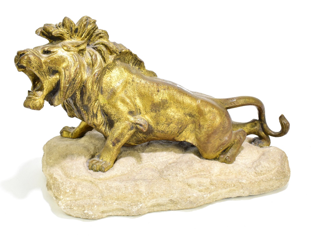 ROBERT BOUSQUET (1888-1917); a gilt bronze model of a stalking lion, signed to white stone base,