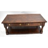 A reproduction oak low rectangular coffee table with two drawers and slatted undertier, raised on