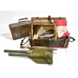 A mixed group of military equipment including entrenching tools, rope pulls, button guards, a