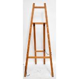 An artist’s easel with indistinct label, height 181cm. Additional InformationScuffs scrapes and