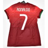 CRISTIANO RONALDO; a Portugal Nike junior 2014 home shirt with printed number '7' to front, signed