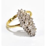 A yellow metal mounted diamond lozenge shaped ring stamped 18ct to inner band, the central stone