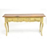 A contemporary painted pine console table with three drawers, raised on cabriole supports, length