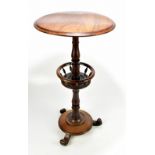 A Victorian rosewood sewing table with circular top raised on baluster column, with central