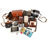 A group of cameras and accessories including a Minolta SR-1 camera with lens, a Zeiss Nettar camera,