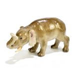 MEISSEN; a small model of an elephant with trunk raised, blue painted crossed sword marks to base,