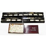 A vintage mahjong set with bamboo backed tiles in inscribed box with sliding lid, sold with a set of