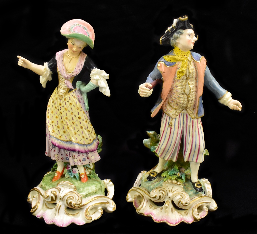 DERBY; a pair of 18th century figures, a dandy wearing tricorn hat and his companion both on gilt