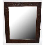 A large oak framed mirror with fretwork detail and bevelled glass, 96 x 81cm.Additional