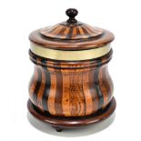 A treen lidded tobacco jar with silver plated collar of bombe outline, on three turned feet,