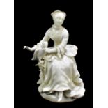 DERBY; an 18th century blanc de chine figure of a young woman with parrot, height 17cm.Additional