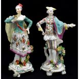 A matched pair of English 18th century figures of dandy and his companion with floral decorated