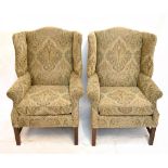 A pair of mahogany framed wing back elbow chairs recently reupholstered in a paisley fabric and