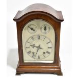 An Edwardian inlaid mahogany mantel clock, the silvered dial set with Roman numerals and two