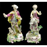 DERBY; a pair of 18th century figures comprising a dandy holding a basket of flowers and his