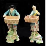 DERBY; a pair of 18th century figures of street vendors both carrying empty baskets, height of
