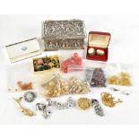 A small group of costume jewellery including brooches and beads, various charms including a 9ct