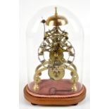 A brass skeleton clock with fusee movement, the applied silvered dial set with Roman numerals,