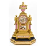 A 19th century French ormolu mantel clock with urn surmounts and hand painted porcelain panels and