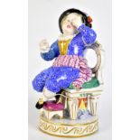 MEISSEN; a 19th century figure of a boy wearing a blue suit seated on a balloon back dining chair,