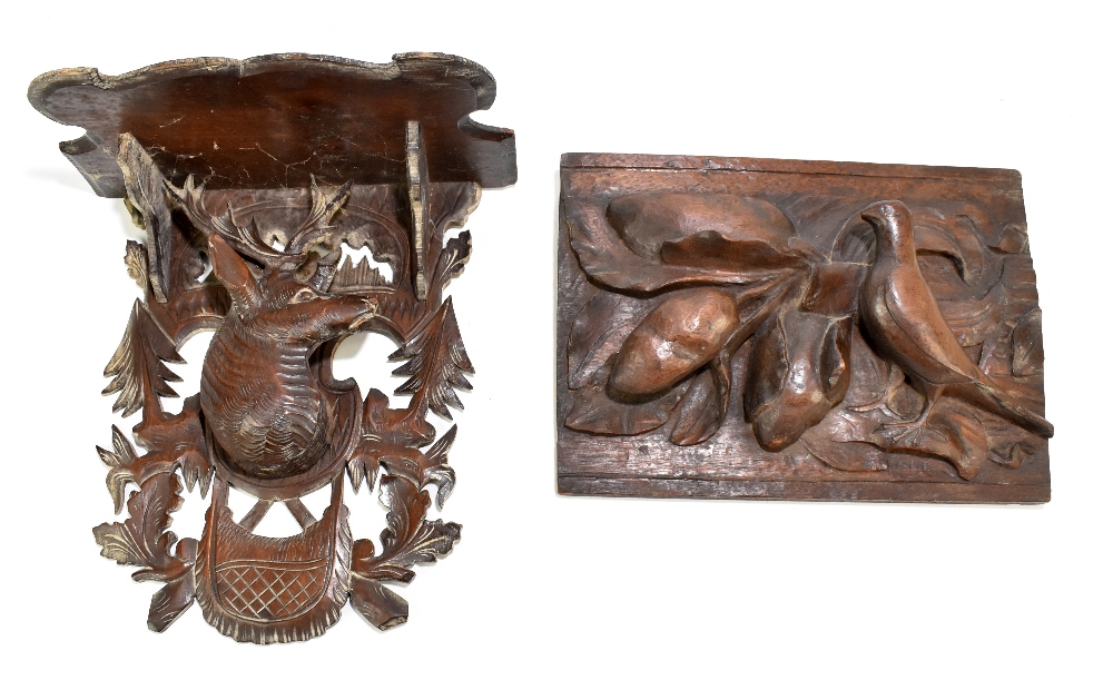 A Black Forest carved oak wall bracket decorated with a central stag, height 31cm, together with a