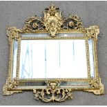 An early 20th century gilt gesso wall mirror of rectangular form, with pierced ornate scrolling
