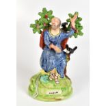 An early 19th century Staffordshire pearlware figure 'Elijah' with bocage and ravens by his side,