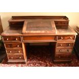 A Victorian mahogany Dickens desk, the raised back with three quarter gallery above two short