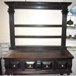 A circa 1900 oak dresser incorporating earlier elements, the open rack with fluted uprights above