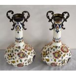 ATTRIBUTED TO FISCHER; a pair of metal mounted floral decorated bottle vases, indistinct impressed