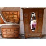 A late Victorian/Edwardian walnut three piece bedroom suite comprising oval mirrored door wardrobe