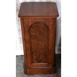 A Victorian figured walnut pot cupboard with moulded rectangular top above arched panel door