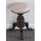 A Victorian walnut adjustable piano stool with padded seat, turned central column and three knee